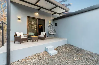a house with a patio with chairs and a table at Brand-New 6BD Giant with Private Pool by SPCR in Potrero