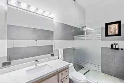 a bathroom with a sink and a toilet and a mirror at Brand-New 6BD Giant with Private Pool by SPCR in Potrero