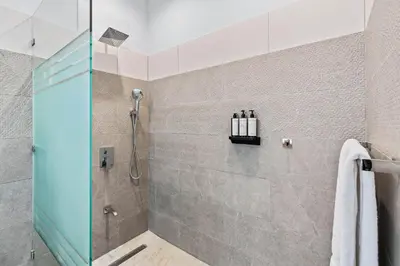a bathroom with a shower with a glass door at Brand-New 6BD Giant with Private Pool by SPCR in Potrero