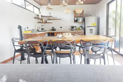 a kitchen and dining room with a wooden table and chairs at Casas Plamont in Fortuna