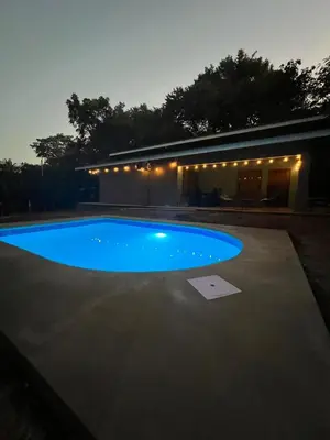 a large blue swimming pool in front of a building at Casa Encanto in Puntarenas