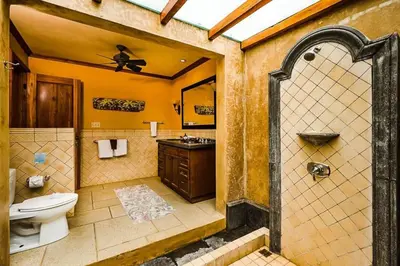 a bathroom with a toilet and a sink at Sunset & OceanView Terrace, Pool, Beach and Grill in Tamarindo