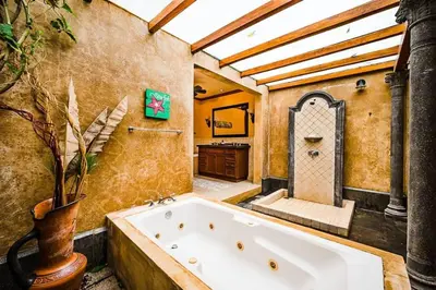a bathroom with a large tub in a room at Sunset & OceanView Terrace, Pool, Beach and Grill in Tamarindo
