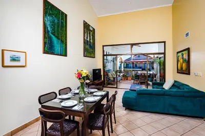 a living room with a table and a couch at Family Setting, Big Pool Beach facing in towns in Tamarindo