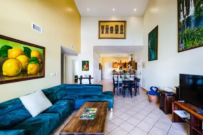 a living room with a blue couch and a table at Family Setting, Big Pool Beach facing in towns in Tamarindo