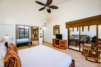a bedroom with a bed and a living room at Family Setting, Big Pool Beach facing in towns in Tamarindo