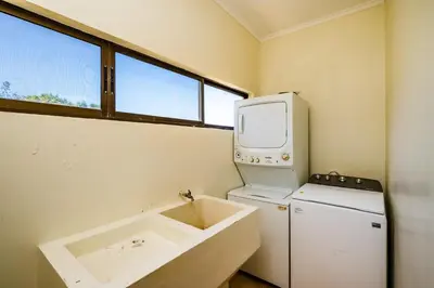 a small kitchen with a refrigerator and a microwave at Family Setting, Big Pool Beach facing in towns in Tamarindo