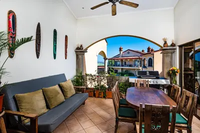 a patio with a couch and a table and a house at Family Setting, Big Pool Beach facing in towns in Tamarindo