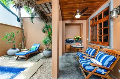 a patio with two chairs and a table at Private Pool, 3bd Villa near the Beach in Tamarindo
