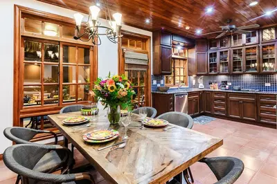 a large kitchen with a wooden table and chairs at Private Pool, 3bd Villa near the Beach in Tamarindo