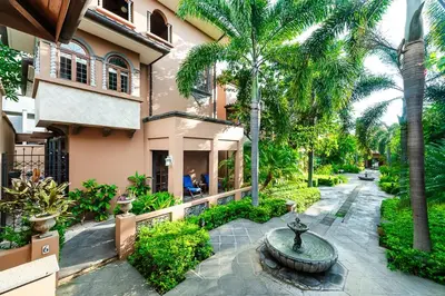 a courtyard with a fountain in front of a building at Private Pool, 3bd Villa near the Beach in Tamarindo