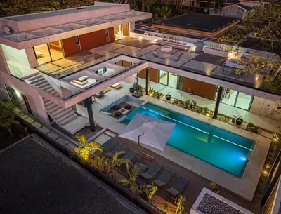 an aerial view of a house with a swimming pool at New 6 bd Modern Home Walk to Beach in Tamarindo