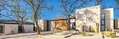 a modern house with trees in front of it at New 6 bd Modern Home Walk to Beach in Tamarindo