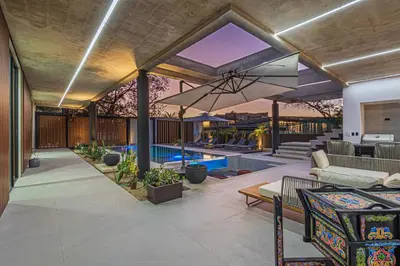 an outdoor living room with a pool and a patio at New 6 bd Modern Home Walk to Beach in Tamarindo
