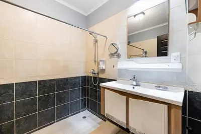 a bathroom with a sink and a mirror at Pool and Private rooftop access in town! in Tamarindo
