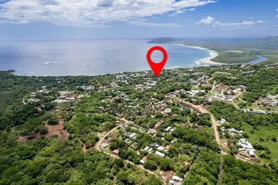 a red marker in the air over a city at Pool and Private rooftop access in town! in Tamarindo