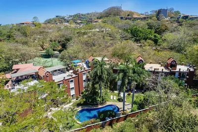 an aerial view of a resort with a pool at Pool and Private rooftop access in town! in Tamarindo