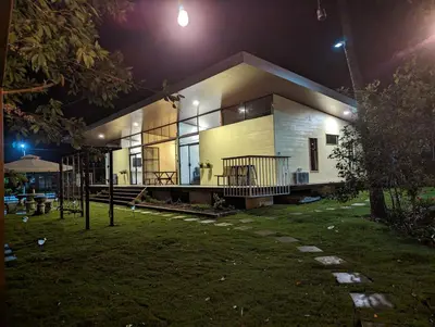 a house is lit up at night at Yellow House - Country house near La Fortuna in San Ramón