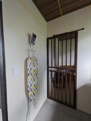 a room with a door with a racket on the wall at Yellow House - Country house near La Fortuna in San Ramón