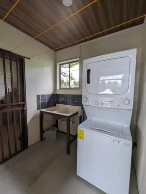 a kitchen with a stove and a table in a room at Yellow House - Country house near La Fortuna in San Ramón