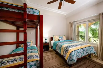 a bedroom with two bunk beds and a window at Oceanview Escape Large Pool and 247 Security! in Tamarindo