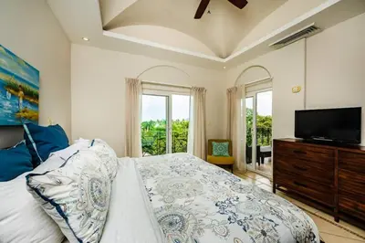 a bedroom with a bed and a flat screen tv at Oceanview Escape Large Pool and 247 Security! in Tamarindo