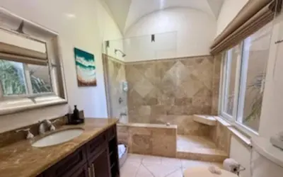 a bathroom with a shower and a sink and a tub at Oceanview Escape Large Pool and 247 Security! in Tamarindo