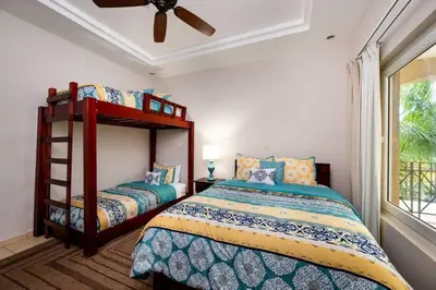 a bedroom with two beds and a ceiling fan at Oceanview Escape Large Pool and 247 Security! in Tamarindo