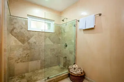 a bathroom with a shower with a glass door at Oceanview Escape Large Pool and 247 Security! in Tamarindo