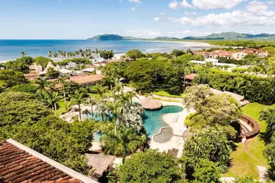 an aerial view of a resort with a pool and a beach at Oceanview Escape Large Pool and 247 Security! in Tamarindo