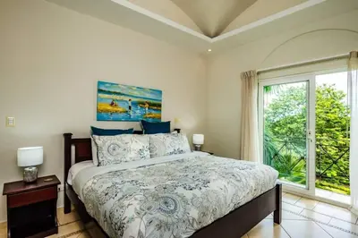 a bedroom with a bed and a large window at Oceanview Escape Large Pool and 247 Security! in Tamarindo