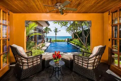 a patio with a table and chairs and a swimming pool at Exclusive Beachfront Villa Private Pool & BBQ in Tamarindo