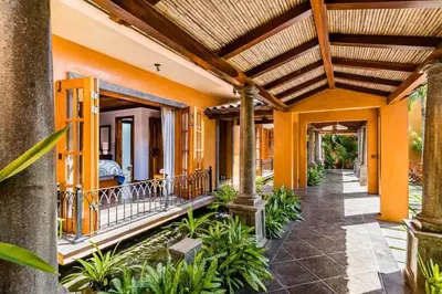 an image of a house with orange walls at Exclusive Beachfront Villa Private Pool & BBQ in Tamarindo
