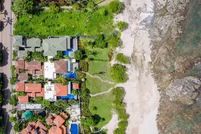 an aerial view of houses and a beach at Exclusive Beachfront Villa Private Pool & BBQ in Tamarindo