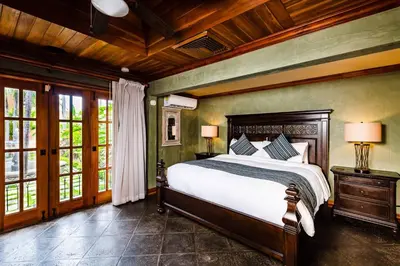 a bedroom with a large bed in a house at Exclusive Beachfront Villa Private Pool & BBQ in Tamarindo