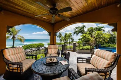 an outdoor patio with a table and chairs and the ocean at Exclusive Beachfront Villa Private Pool & BBQ in Tamarindo