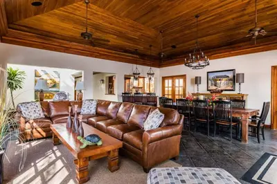 a living room with a leather couch and a table at Exclusive Beachfront Villa Private Pool & BBQ in Tamarindo