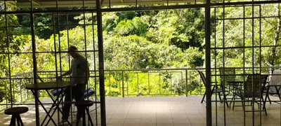 a person sitting at a table in a room with a window at Maison tranquille in Rivas