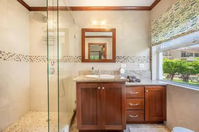 a bathroom with a sink and a glass shower at Beautiful beachfront 2BR condo, with full kitchen in Tamarindo