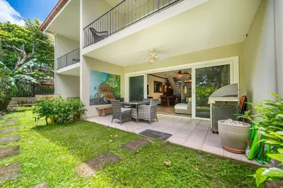 a house with a patio with a table and chairs at Beautiful beachfront 2BR condo, with full kitchen in Tamarindo