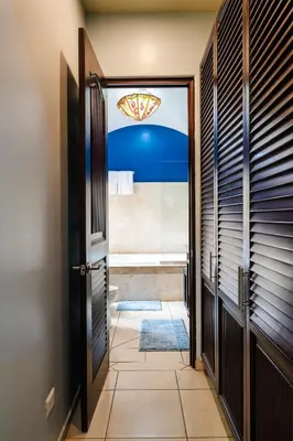 a hallway with a door leading to a bathroom at Oceanview in town Huge Pool Beach acss in Tamarindo