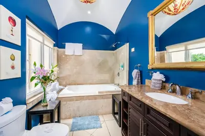 a blue bathroom with a tub and a sink at Oceanview in town Huge Pool Beach acss in Tamarindo