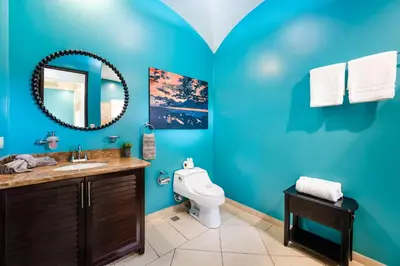 a blue bathroom with a toilet and a sink at Oceanview in town Huge Pool Beach acss in Tamarindo