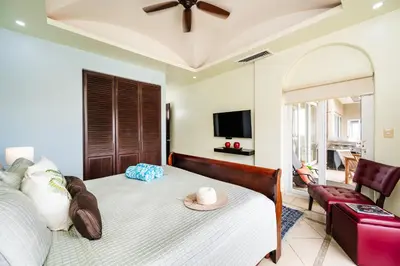 a bedroom with a bed with a hat on it at Oceanview in town Huge Pool Beach acss in Tamarindo
