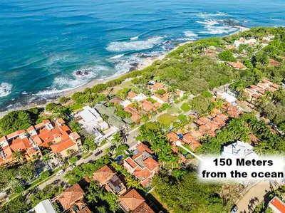 an aerial view of a house near the ocean at Exclusive private pool and steps to the beach in Tamarindo