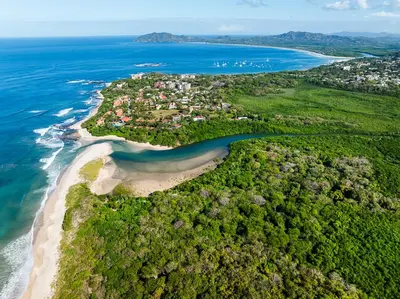 an aerial view of a small island in the ocean at Exclusive private pool and steps to the beach in Tamarindo