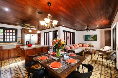 a living room with a table and a couch at Exclusive private pool and steps to the beach in Tamarindo