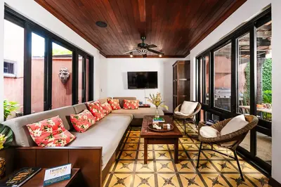 a living room with a couch and a table at Exclusive private pool and steps to the beach in Tamarindo