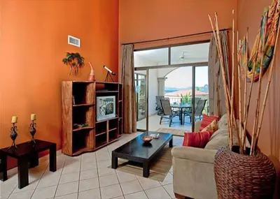 a living room with a couch and a table at Beach Facing, large pool & guard in the town in Tamarindo