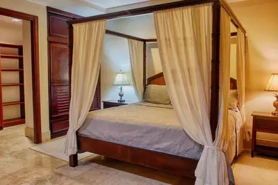a bedroom with a canopy bed with curtains at Beachfront, Sunset, & Ocean Views with Elevator in Tamarindo